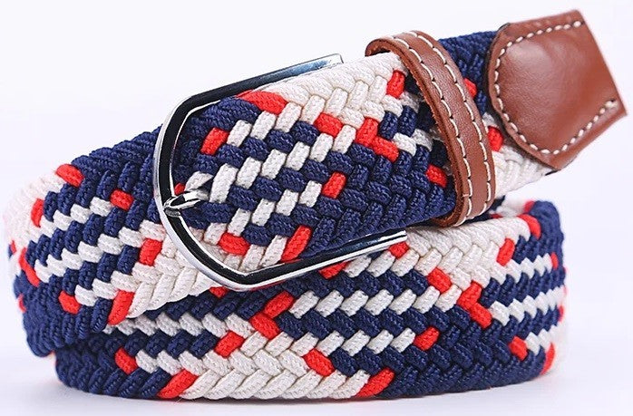 A braided elastic web belt with a navy blue, white, and red woven pattern, featuring a silver-tone metal buckle and brown leather accents.