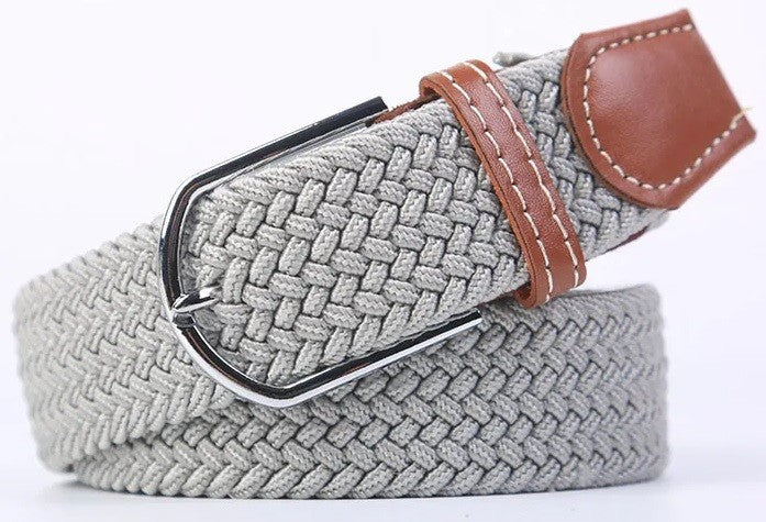 A light gray braided elastic belt with a silver metal buckle and brown leather accents, coiled on a white background.