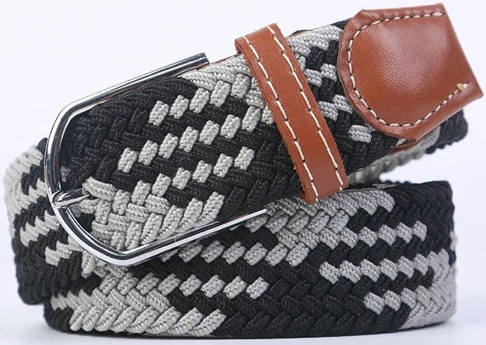 A woven elastic belt with a black and gray herringbone pattern, a brown leather keeper loop, and a silver-tone metal buckle, shown on a white background.