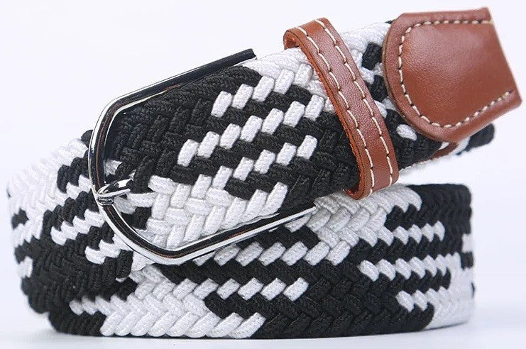 A woven elastic belt with a black and white pattern, a brown leather keeper loop, and a silver-tone metal buckle, shown on a plain white background.