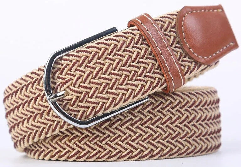 A woven elastic belt with a brown and beige herringbone pattern, a brown leather keeper loop, and a silver metal buckle, shown on a white background.