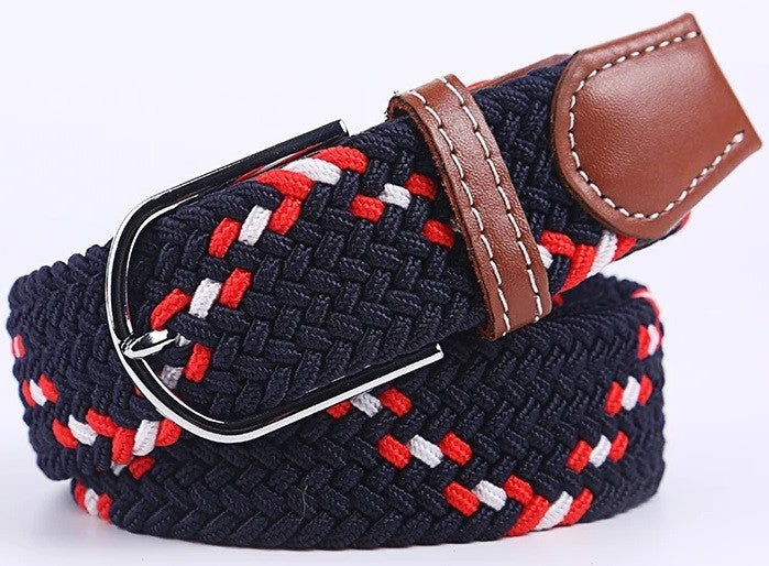 A woven elastic belt with a navy blue base, red and white braided accents, and a brown leather keeper loop with white stitching and a silver metal buckle.