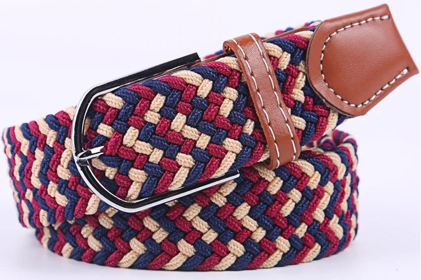 A woven elastic belt with a red, navy, and beige chevron pattern, featuring a brown leather keeper loop and a silver-tone metal buckle.